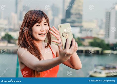 Happy Asian Woman With Phone Taking Selfie Or Having Video Call And