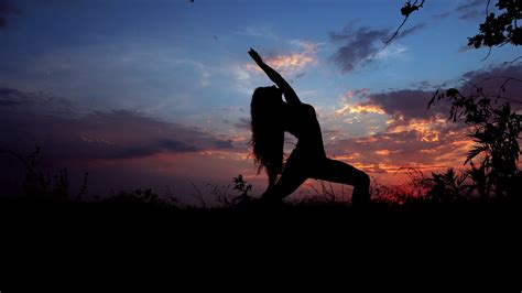 Silhouette Against Bright Color Sunset Of One Young Graceful Girl