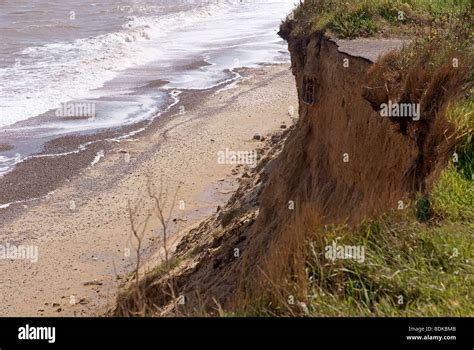 Coastal Cliff Erosion With Exposed And Severed Drainage Pipes Under