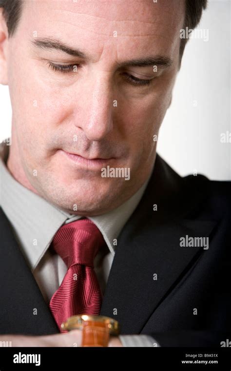 Businessman Looking At Wristwatch Stock Photo Alamy