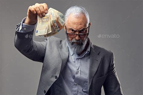 Rich Elderly Business Person Dressed In Suit Holding Money Stock Photo