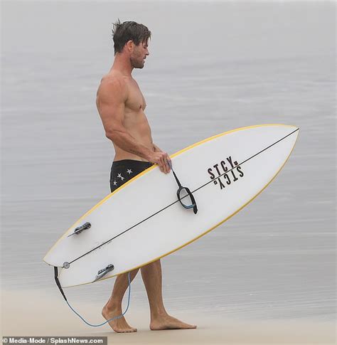 Chris Hemsworth Flaunts Physique While Surfing In Star Spangled Swim Trunks At Byron Bay Beach