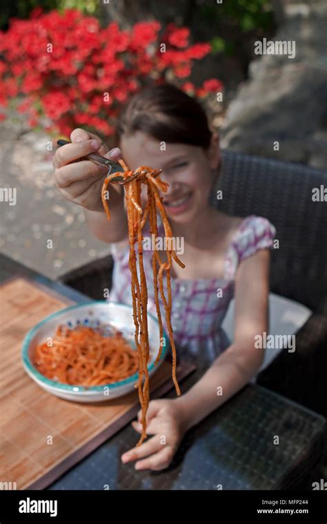 Seven Year Old Girl Is Eating Spaghetti Outside Stock Photo Alamy