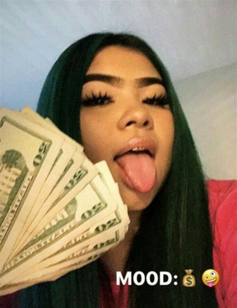 A Woman Sticking Out Her Tongue And Holding Money In Front Of Her Face