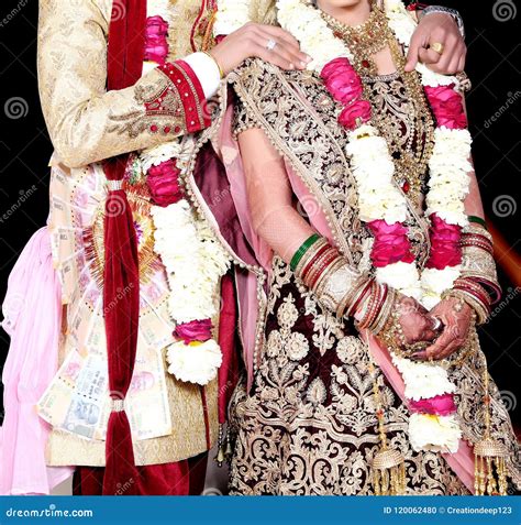 Indian Bride And Groom Pose For Beautiful Portraits After Their Colorful Jaimala Ceremony Stock