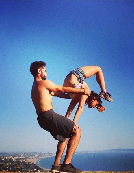 A Man Doing A Handstand On Top Of A Mountain