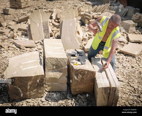 Quarry Worker Splitting Sandstone In Yorkshire Stone Quarry Elevated