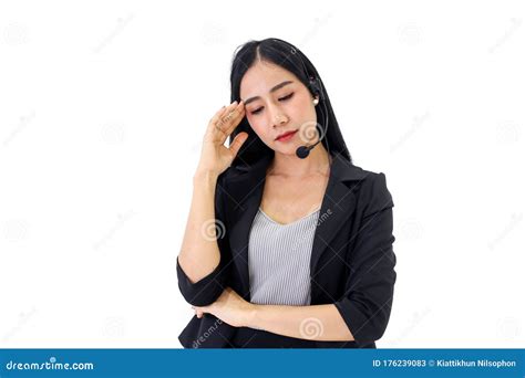 Beautiful Asian Woman Serious Call Center Operator In Wireless Headset Talking With Customer In