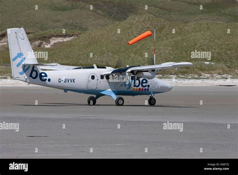 Twin Otter Operated By Flybe Taxiing On The Baech At Barra Airport
