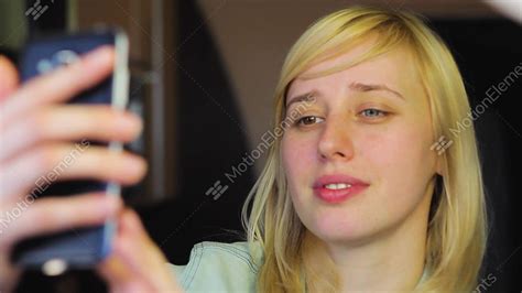European Blonde Girl With Different Eyes Takes Selfie On Phone