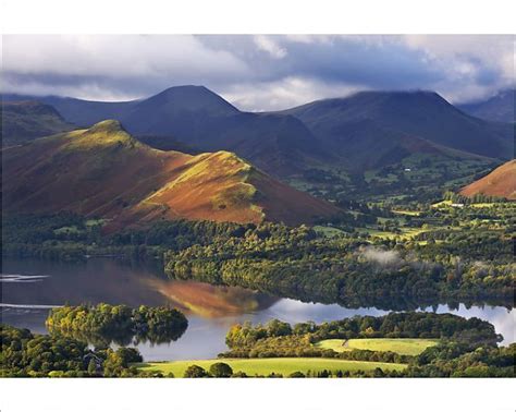 An Aerial View Of Mountains And Lakes In The Country Side With Clouds