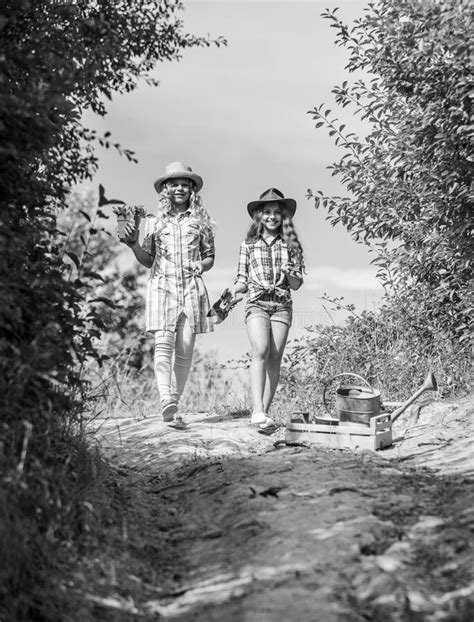 Girls With Gardening Tools Agriculture Concept Adorable Girls In Hats Going Planting Plants