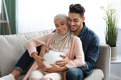 Happy Expectation Loving Arab Husband Hugging And Touching Pregnant