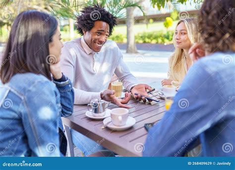 Multi Ethnic Group Of Friends Having A Drink Together In An Outdoor Bar Stock Image Image Of