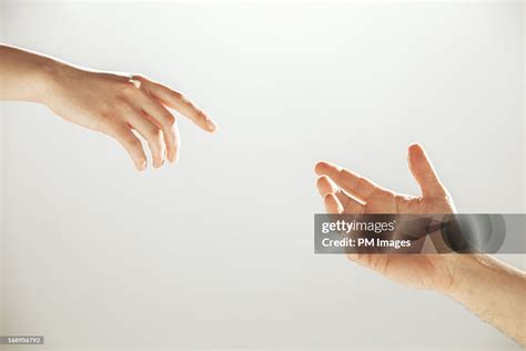 Hands Reaching Towards Each Other Bildbanksbilder Getty Images