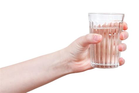 Premium Photo Hand Holds Clear Water In Glass Isolated