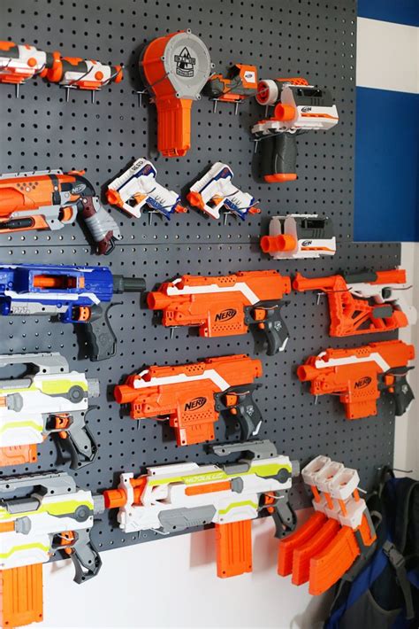 The easiest nerf gun storage wall for under $50. Nerf Wall Pegboard Storage - Sugar Bee Crafts