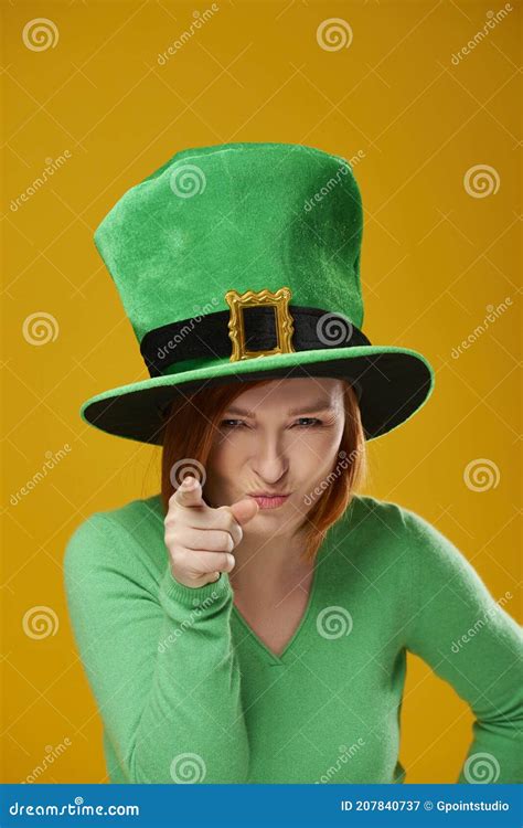 Portrait Of Playful Woman With Leprechaun S Hat Pointing At Camera