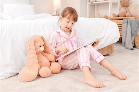 Premium Photo Cute Little Girl Reading Bedtime Story At Home