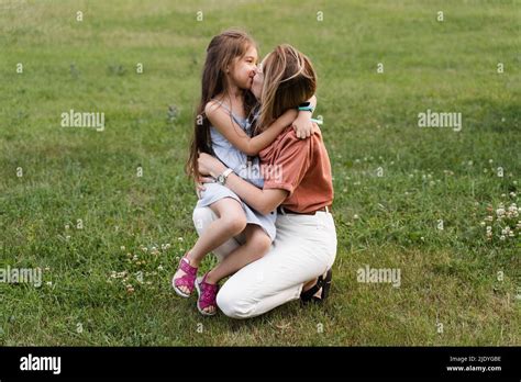 Mom and daughter embrace and smile. Family values. Happy family