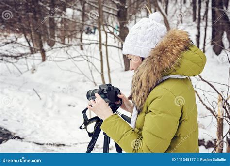 Woman Amateur Photographer Takes A Winter Landscape On The Lake In The Forest Copy Space Stock