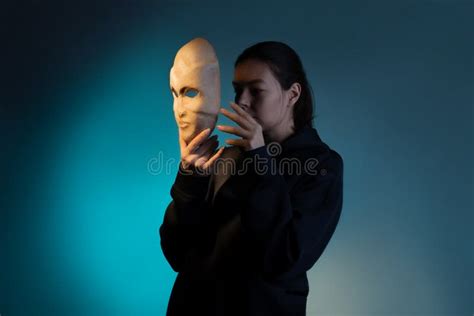 Hiding Behind A Mask A Young Woman In A Dark Hoodie Hides Her Face