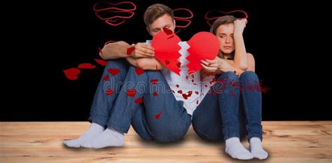 Composite Image Of Young Couple Holding Broken Heart Stock Photo