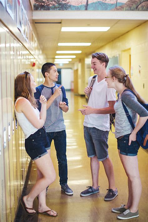 Group Of High School Teens Hanging Out In School Hallway Talking By Stocksy Contributor Rob