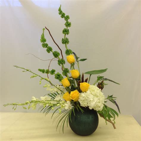 Raw yellow tomatoes are excellent for slicing onto sandwiches or chopping into salads. White and yellow floral arrangement with orchids by Nancy ...