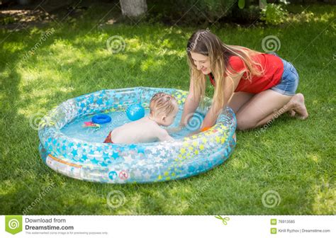 Happy Mother Playing With Her Baby Boy In Outdoor Swimming Pool Stock