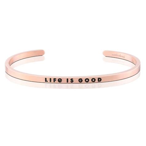 A Rose Gold Cuff Bracelet With The Words Life Is Good Engraved In Black