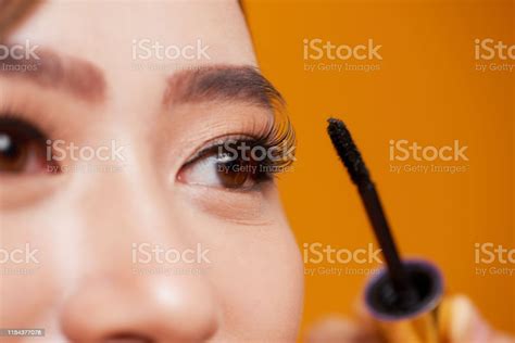 Beautiful Woman Applying Mascara On Her Eyelashes Stock Photo
