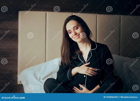 happy pregnant woman resting in bed caressing belly stock image image of pajama expectation