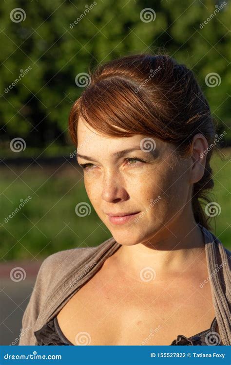 Portrait Of Beautiful Serious Middle Aged Woman With Calm Face Looking