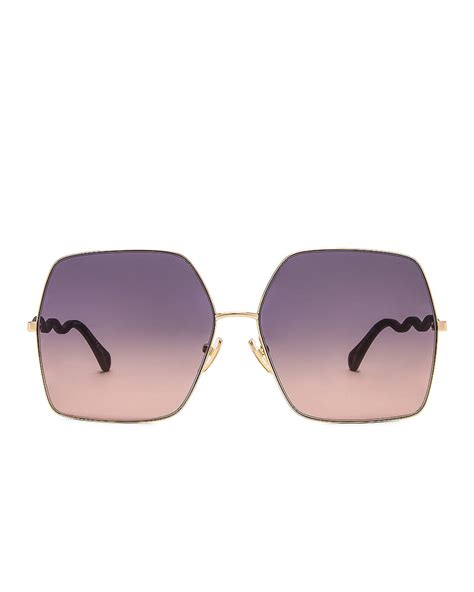 chloe noore oversize square sunglasses in violet and gold fwrd