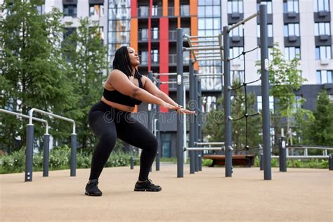 Fat African Woman Is Engaged In Workout On Sports Ground Outdoors