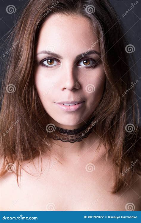 Brunette Woman Looking Portrait On A Black Background Stock Photo