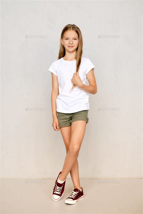 Full Length Portrait Of Teenager Girl Standing Straight Stock Photo By