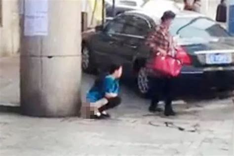 Sickening Video Shows Woman Pooing In Street Outside Train Station As She Ignores Passing