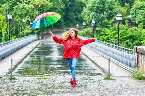 Beautiful Girl With Umbrella Dancing In The Rain Stock Photo Download