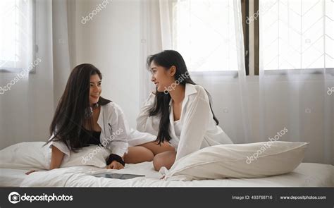 asiática lésbica lgbt casal estão sentados cama quarto com momento — fotografias de stock