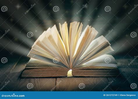 Old Open Book with Falling Stars on Wooden Table, Fairytale Book with