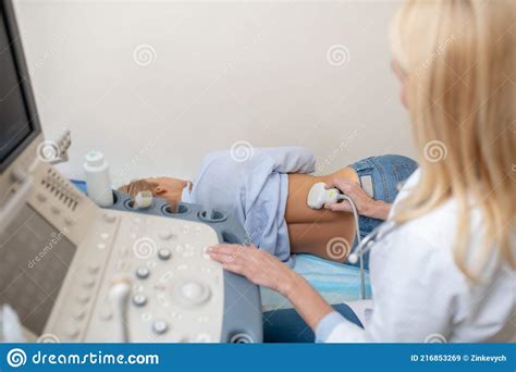 Ultrasound Specialist Conducting Examination And Patient Stock Image