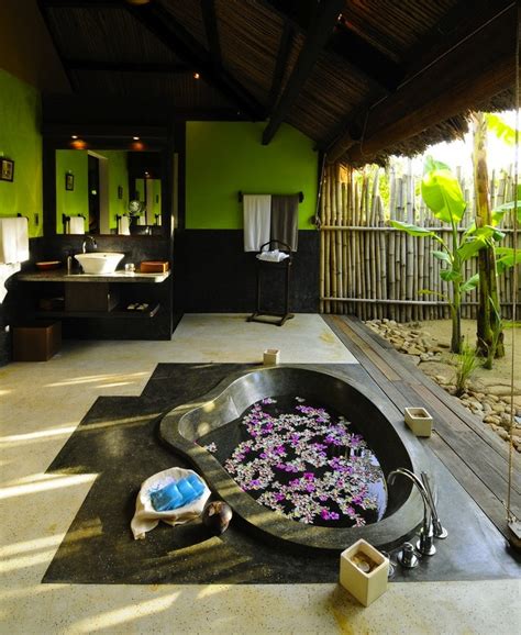 Create a wall of round stones in your bathroom. 42 Amazing Tropical Bathroom Décor Ideas | DigsDigs