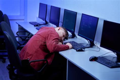 The Man Fell Asleep At The Computer Desk Tired After A Long Day At