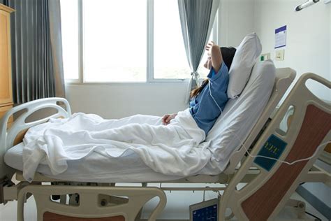 Portrait Of Sickness Patient Woman Lying On Hospital Bed Feeling Sad And Depressed Worried Stock