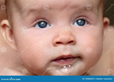 Close Up Of Newborn Baby Grey Eyes Drooling From Mouth Beautiful Healthy Girl Stock Image