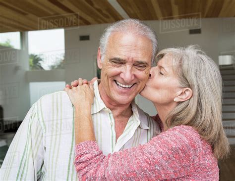 Close Up Of Older Caucasian Woman Kissing Husband Stock Photo Dissolve