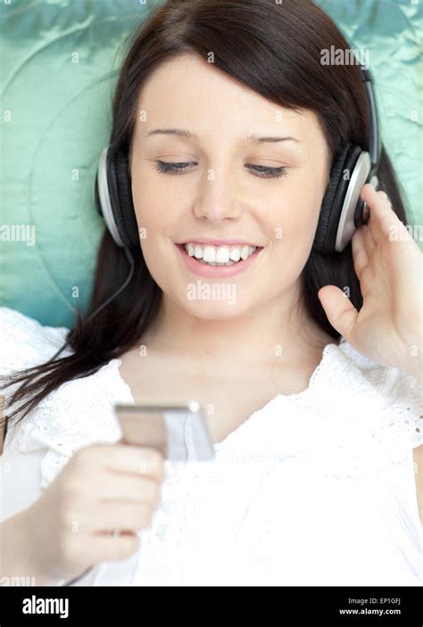 Pretty Woman Listening Music Lying On A Sofa Stock Photo Alamy