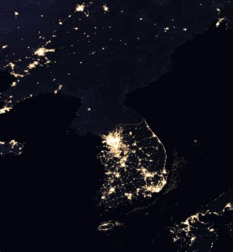Satellite Image Of The Korean Peninsula At Night Showing North Korea In Almost Complete